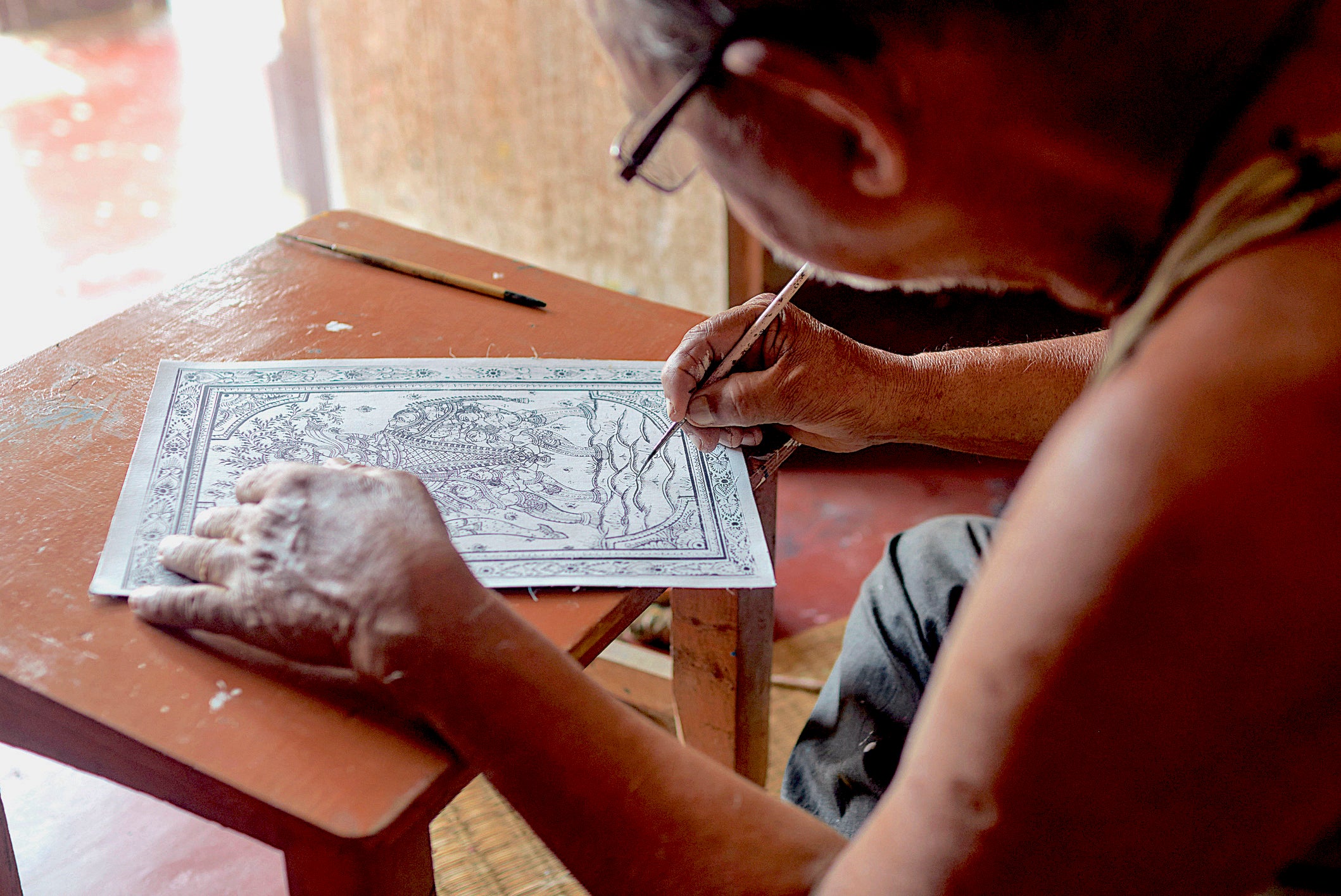 Artist painting Pattachitra on Canvas