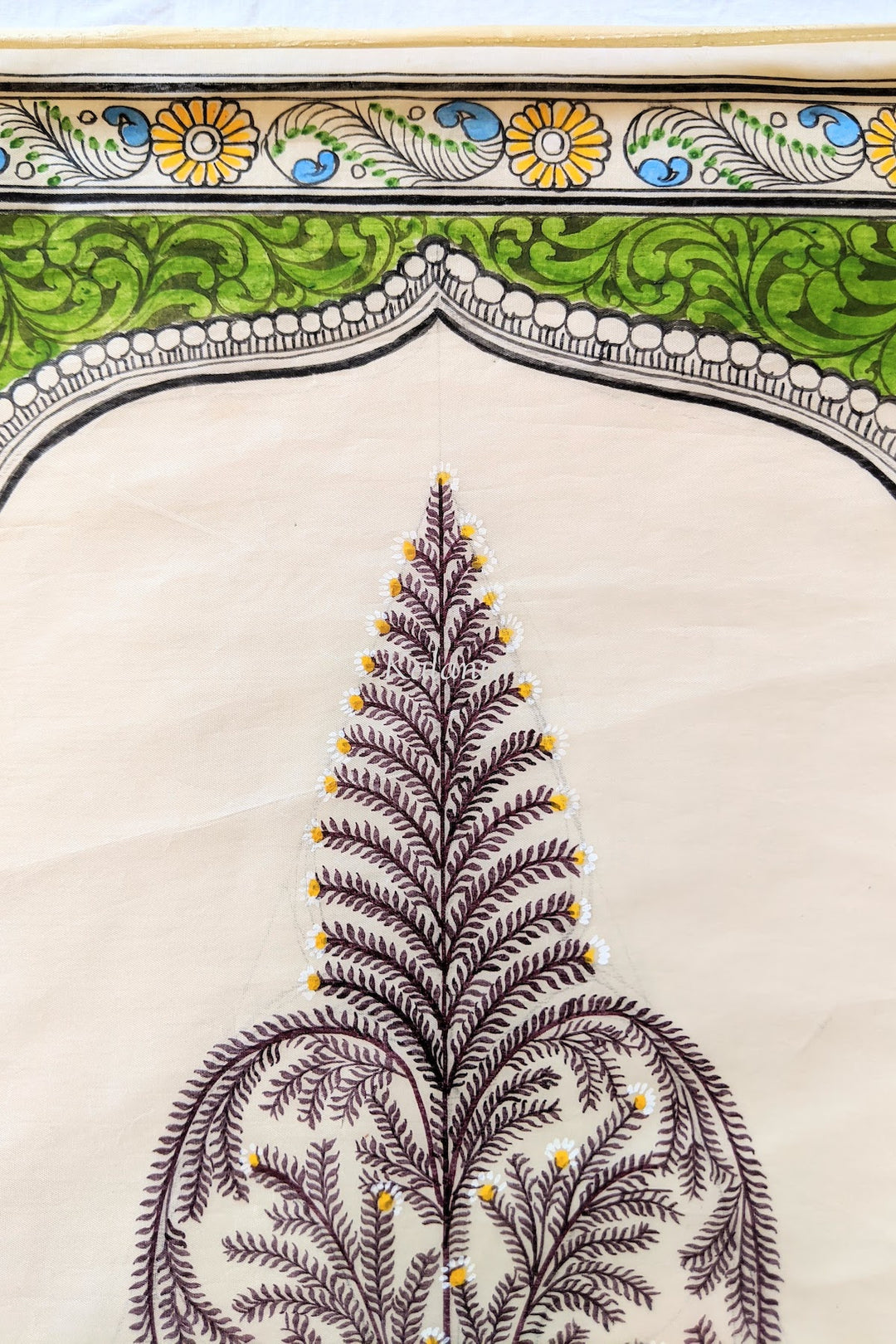 Detailed view of the tree top and border of the Saura painting