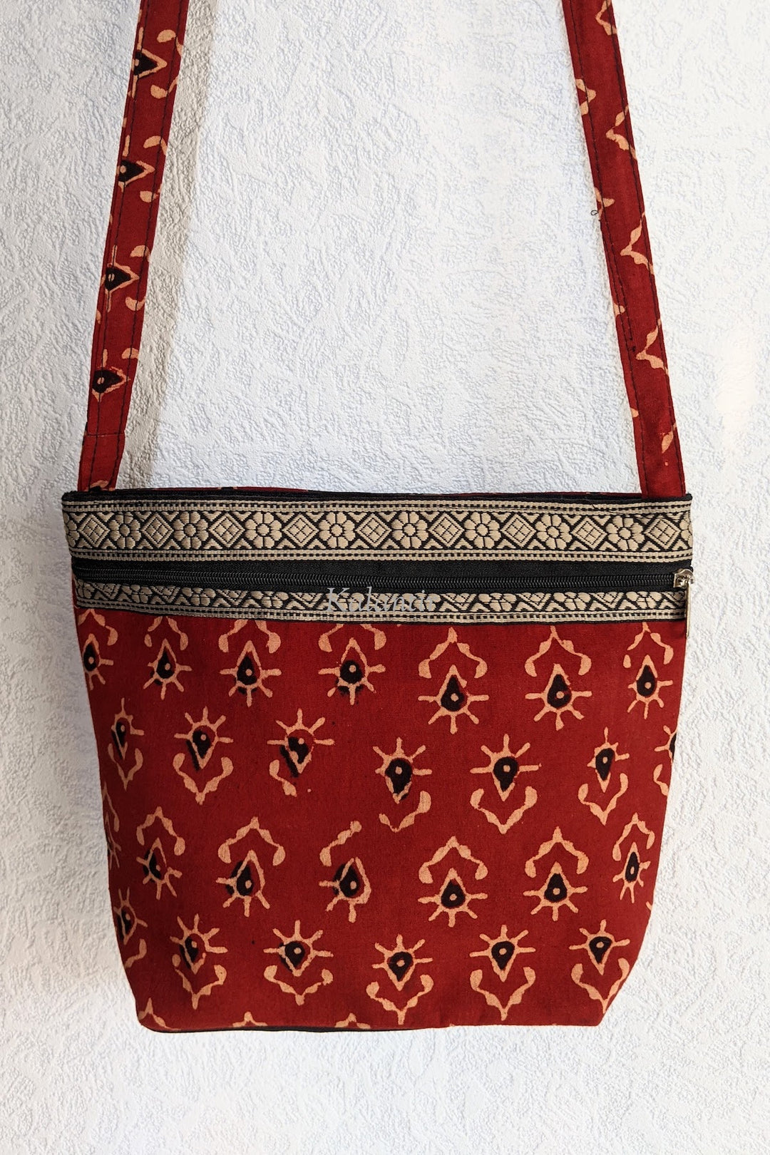 Closer view of the Casual Block Printed Colored Sling Bag in Cinnabar Red
