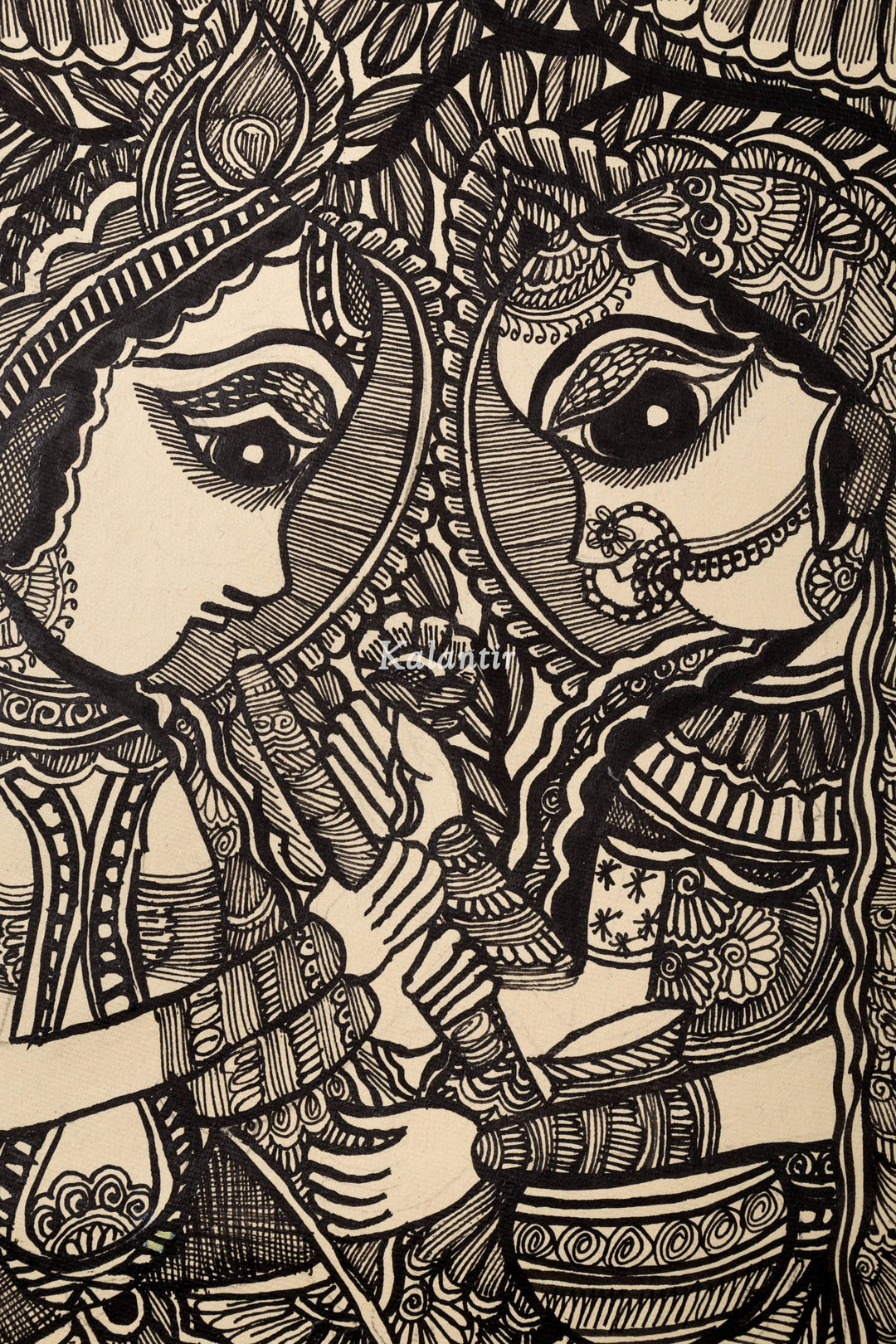 Focussed view of top half of this black and white Madhubani painting showing faces of Radha and Krishna with flute and matki in hands respectively.